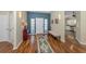 Spacious foyer with hardwood floors, a stylish rug, and an adjacent doorway at 13314 Prentice Ave, Port Charlotte, FL 33953