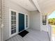 Welcoming front door, featuring sidelights and a cozy covered porch at 13314 Prentice Ave, Port Charlotte, FL 33953