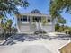 Charming coastal home with a two-story entrance, a dual garage, and lush tropical landscaping at 13314 Prentice Ave, Port Charlotte, FL 33953