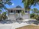 Charming coastal home with a two-story entrance, a dual garage, and lush tropical landscaping at 13314 Prentice Ave, Port Charlotte, FL 33953