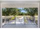 Inviting front porch with a scenic view of the neighborhood, featuring a railing and stairs at 13314 Prentice Ave, Port Charlotte, FL 33953