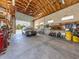 Spacious garage with high ceilings, tools, and a car parked inside at 13314 Prentice Ave, Port Charlotte, FL 33953