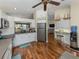 Bright open kitchen featuring white cabinets and stainless steel appliances with views into the living area at 13314 Prentice Ave, Port Charlotte, FL 33953