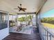 Screened lanai features ample seating, ceiling fan, and views of the landscaped backyard at 13314 Prentice Ave, Port Charlotte, FL 33953