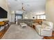 Bright living room with a high ceiling, large sectional sofa, and an open floor plan at 13314 Prentice Ave, Port Charlotte, FL 33953