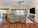 Cozy living room with a vaulted ceiling, fireplace, hardwood floors, and water views at 13314 Prentice Ave, Port Charlotte, FL 33953