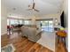 Bright open concept living room with a dining area and fireplace leading to an outdoor balcony at 13314 Prentice Ave, Port Charlotte, FL 33953