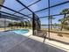 Sparkling pool in screened lanai offering peaceful water views with a spacious deck at 13314 Prentice Ave, Port Charlotte, FL 33953