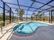 Inviting pool in a screened enclosure, surrounded by lush tropical landscaping and offering a waterfront view at 13314 Prentice Ave, Port Charlotte, FL 33953