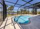 A screened-in pool offers picturesque lake views with a spacious deck for entertaining at 13314 Prentice Ave, Port Charlotte, FL 33953