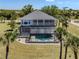 Aerial view of the home featuring a screened-in lanai and kidney-shaped pool at 13314 Prentice Ave, Port Charlotte, FL 33953