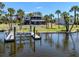 Waterfront home with a private boat dock and lush landscaping at 13314 Prentice Ave, Port Charlotte, FL 33953