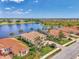 Lovely neighborhood with lake view homes, lush landscaping, and beautiful tile roofs from an aerial perspective at 138 Rimini Way, North Venice, FL 34275