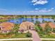 Attractive single-Gathering homes with lake views and lush landscaping from an aerial perspective at 138 Rimini Way, North Venice, FL 34275
