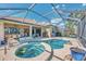 Expansive backyard features a pool, spa, outdoor seating, and a screened enclosure, perfect for entertaining at 138 Rimini Way, North Venice, FL 34275