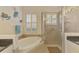 Elegant bathroom featuring a soaking tub, a walk-in shower, and stylish fixtures at 138 Rimini Way, North Venice, FL 34275