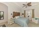 Cozy bedroom featuring a decorative screen headboard and a comfortable chair by the bright window at 138 Rimini Way, North Venice, FL 34275