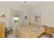 Cozy bedroom featuring a comfortable bed, side table, and window with natural light, offering a relaxing ambiance at 138 Rimini Way, North Venice, FL 34275