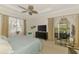 Relaxing bedroom with a ceiling fan, a comfortable bed, and views of the outside scenery at 138 Rimini Way, North Venice, FL 34275