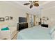 Bright bedroom featuring access to the lanai, ceiling fan and a comfortable white chair at 138 Rimini Way, North Venice, FL 34275