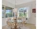 Bright dining area, glass table, and natural light at 138 Rimini Way, North Venice, FL 34275