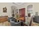 Dining room with glass-top table, leather chairs, and access to multiple rooms of the home at 138 Rimini Way, North Venice, FL 34275