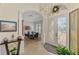 Welcoming foyer with a chandelier, arched doorways, tile flooring, and views of the dining area at 138 Rimini Way, North Venice, FL 34275