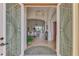 Elegant foyer showcasing decorative glass doors, high ceilings, and an open view to the living area at 138 Rimini Way, North Venice, FL 34275