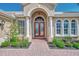 Charming front entrance featuring a beautiful door, well-maintained landscaping, and a brick walkway at 138 Rimini Way, North Venice, FL 34275