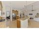 Open-concept kitchen featuring bar seating, stainless steel appliances, and seamless flow into living areas at 138 Rimini Way, North Venice, FL 34275