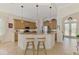 Kitchen with breakfast bar and tan cabinets at 138 Rimini Way, North Venice, FL 34275