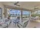 Inviting screened-in lanai offers comfortable seating and dining areas with scenic lake views for outdoor enjoyment at 138 Rimini Way, North Venice, FL 34275