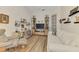 Comfortable living room with wood floors, a white sofa, and shelving for books and decor at 138 Rimini Way, North Venice, FL 34275