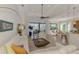 Bright living room featuring tile floors, ceiling fan, and a view of the lanai and pool at 138 Rimini Way, North Venice, FL 34275