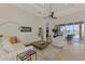Spacious living room with white furniture, tile floors, and a view of the pool and lake at 138 Rimini Way, North Venice, FL 34275