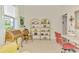 Bright home office with desk, stylish decor, and shelving, offering an inviting and functional workspace at 138 Rimini Way, North Venice, FL 34275