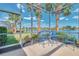 Inviting screened-in patio with comfortable seating and scenic lake view, perfect for relaxing outdoors at 138 Rimini Way, North Venice, FL 34275