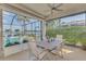 Inviting outdoor dining area with screened enclosure, offering beautiful views of the pool, spa, and water at 138 Rimini Way, North Venice, FL 34275