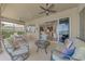 Spacious covered patio with outdoor furniture, perfect for entertaining, and a view of the landscaped backyard at 138 Rimini Way, North Venice, FL 34275
