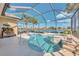 Beautiful pool and spa area surrounded by lush landscaping and a screened enclosure, perfect for relaxation at 138 Rimini Way, North Venice, FL 34275