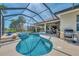 Beautiful screened-in pool with spa, outdoor grill, and patio area perfect for entertaining at 138 Rimini Way, North Venice, FL 34275