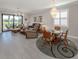 Bright open-concept living space featuring tile floors, chandeliers, dining area, and comfortable seating at 13908 Vadini St, Venice, FL 34293