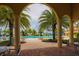 Inviting community pool area with palm trees, lounge chairs, and beautiful landscaping, perfect for relaxation at 13908 Vadini St, Venice, FL 34293