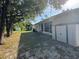 Private, shaded backyard featuring a screened-in porch and storage shed at 1483 Prairie Ter, North Port, FL 34286