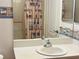 Bathroom vanity featuring a light-themed wall border and a neutral shower curtain at 1483 Prairie Ter, North Port, FL 34286