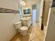 Bathroom featuring tiled floor, vanity with framed mirror, and a toilet at 1483 Prairie Ter, North Port, FL 34286