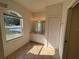 Well-lit bathroom featuring dual sinks, tile flooring, and a window offering natural light at 1483 Prairie Ter, North Port, FL 34286