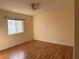 Bright bedroom with wood-look floors, a window, and light-colored walls at 1483 Prairie Ter, North Port, FL 34286