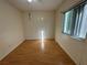 Bright bedroom featuring wood-look floors, a window, and light-colored walls at 1483 Prairie Ter, North Port, FL 34286