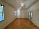 Spacious bedroom with wood laminate flooring, large windows, and patio access for serene living at 1483 Prairie Ter, North Port, FL 34286